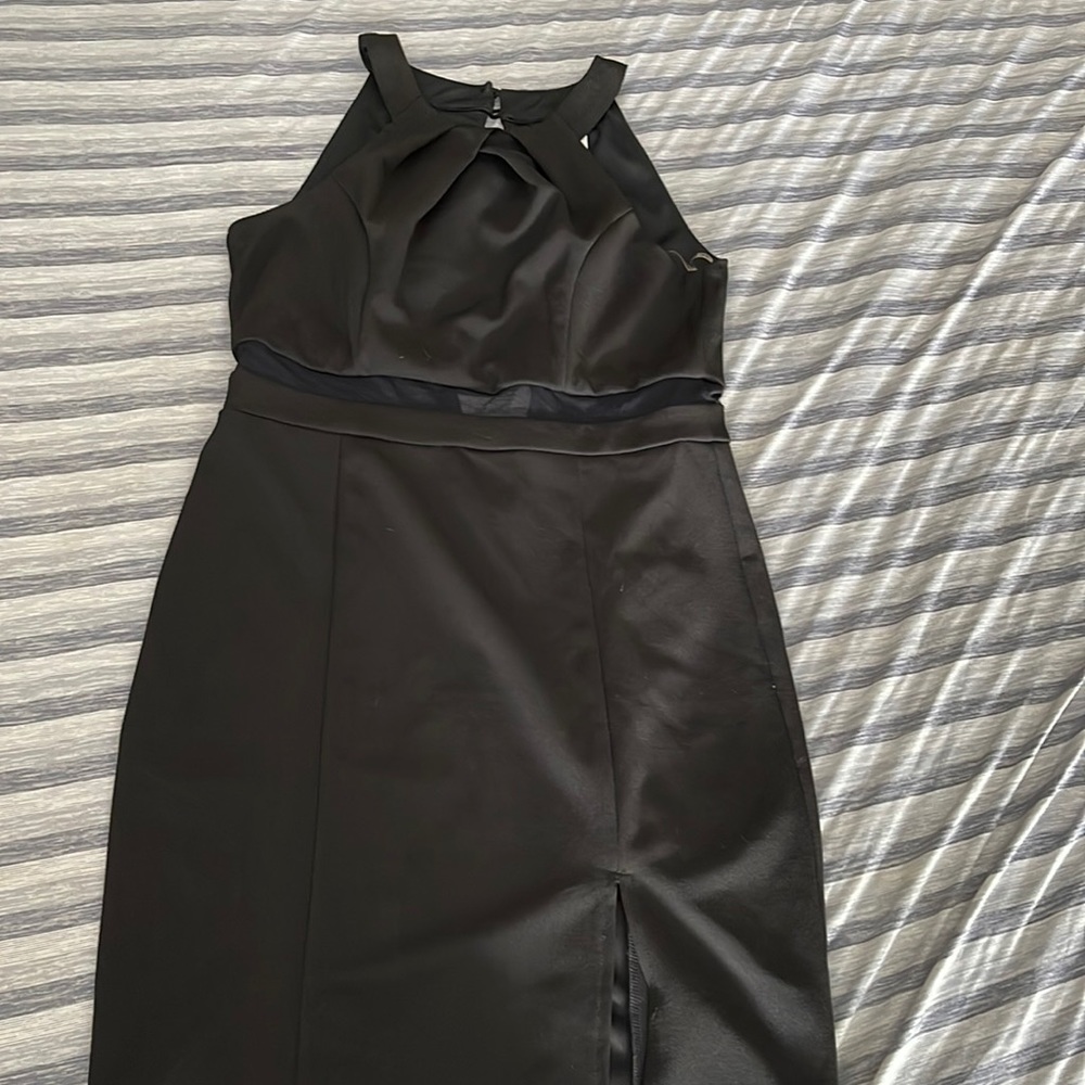 Black above the knee dress with slit over left leg.
